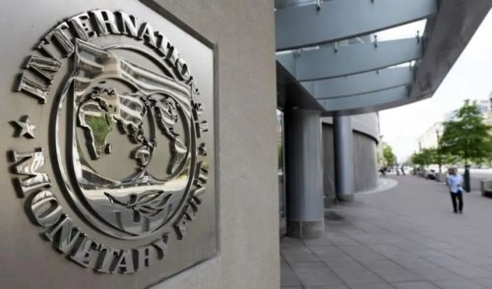 Pedestrians walk past the International Monetary Fund headquarters' complex in Washington Sunday, May 2, 2010. A senior International Monetary Fund official says the IMF's executive board is meeting in Washington to consider how much aid to grant Athens under a massive rescue loan package. (AP Photo/Cliff Owen)