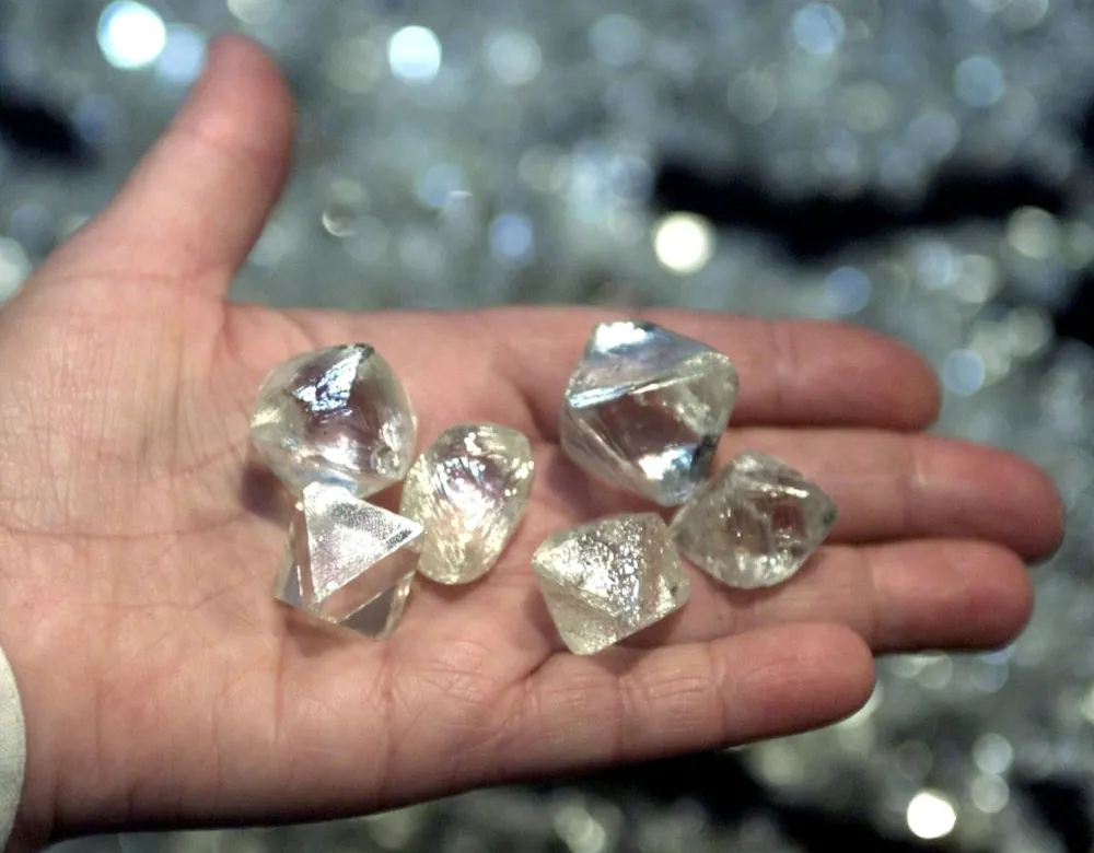 Picture shows a handful of diamonds weighing over 50 carats each, found in various pipes of Yakutia, inspected at a sorting point in the town of Mirny in western Yakutia, August 30, 2001. The kimberlite pipes of Yakutia remain Russia's main source of diamonds. REUTERS/Sergei Karpukhin