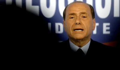 Italian opposition leader Silvio Berlusconi addresses a news conference at the "Forza Italia" headquarter in central Rome April 20, 2001. Berlusconi said that members of his centre-right alliance had received death threats but the government said it had not found any evidence to support the claims. Berlusconi, who leads most polls ahead of a May 13 elections, flew straight back at the ruling centre-left coalition, accusing them of spreading venom, mud and hatred and demonising the opposition. REUTERS/Paolo Cocco