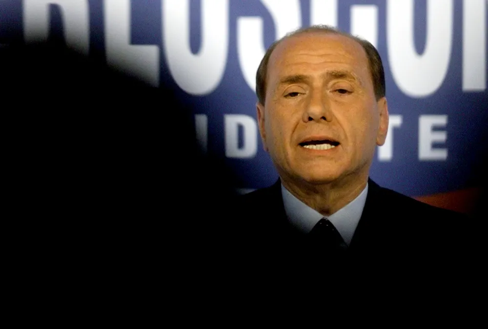 Italian opposition leader Silvio Berlusconi addresses a news conference at the "Forza Italia" headquarter in central Rome April 20, 2001. Berlusconi said that members of his centre-right alliance had received death threats but the government said it had not found any evidence to support the claims. Berlusconi, who leads most polls ahead of a May 13 elections, flew straight back at the ruling centre-left coalition, accusing them of spreading venom, mud and hatred and demonising the opposition. REUTERS/Paolo Cocco