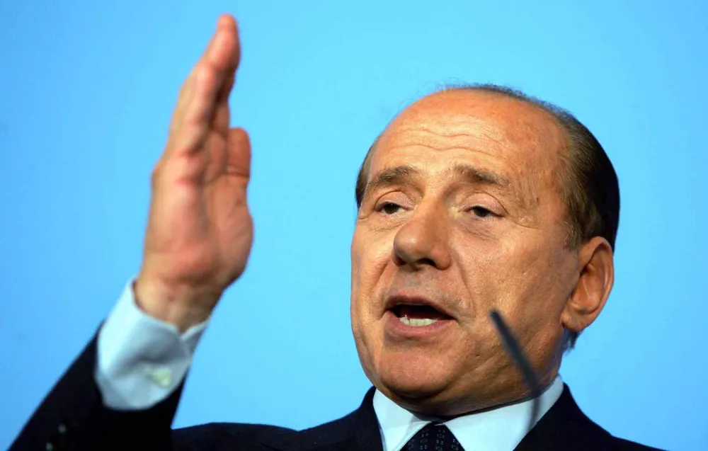  Italian Prime Minister Silvio Berlusconi speaks at a joint news conference with British Prime Minister Tony Blair, at Lancaster House in London, Tuesday July 13, 2004. Blair declined to comment on the Butler report into the intelligence that led Britain into the war with Iraq, which is due to be released to the public on July 1, but denied that the decision was based on "duff intelligence".(AP Photo/David Bebber, pool)