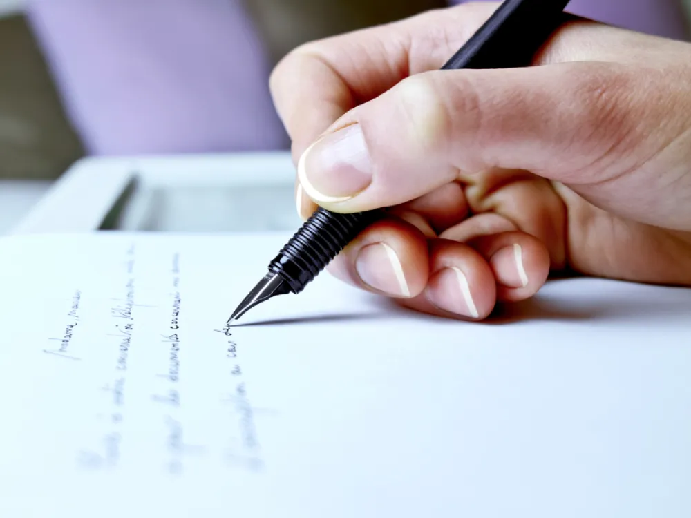 Photography closeup of the hand of a woman about to write