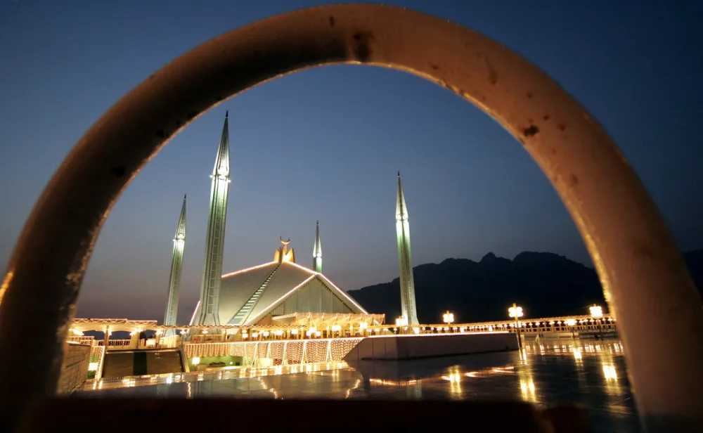 Pakistan's Faisal mosque is bathed in light on the twenty-seventh night of the holy fasting month of Ramadan in Islamabad November 10, 2004. Ramadan, the holiest month of the Islamic lunar calendar, is when devout Muslims refrain from all food, drink or sex during daylight hours and focus on devotion and good works. The Muslim festival of Eid-al-Fitr is then celebrated at the end of Ramadan.   REUTERS/Mian Khursheed