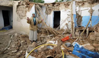 Elamrami Mimou stands in the rubble of a destroyed house in the village of Ait-Kamra, Wednesday Feb.25, 2004. A strong earthquake Tuesday killed more than 550 people in a poor region of northern Morocco. Many survivors braved a chilly, wet night without a home in makeshift tents.The quake shook areas near the coastal city of Al Hoceima, an isolated but picturesque area between the Rif Mountains and the Mediterranean Sea. (AP Photo/Michel Spingler)