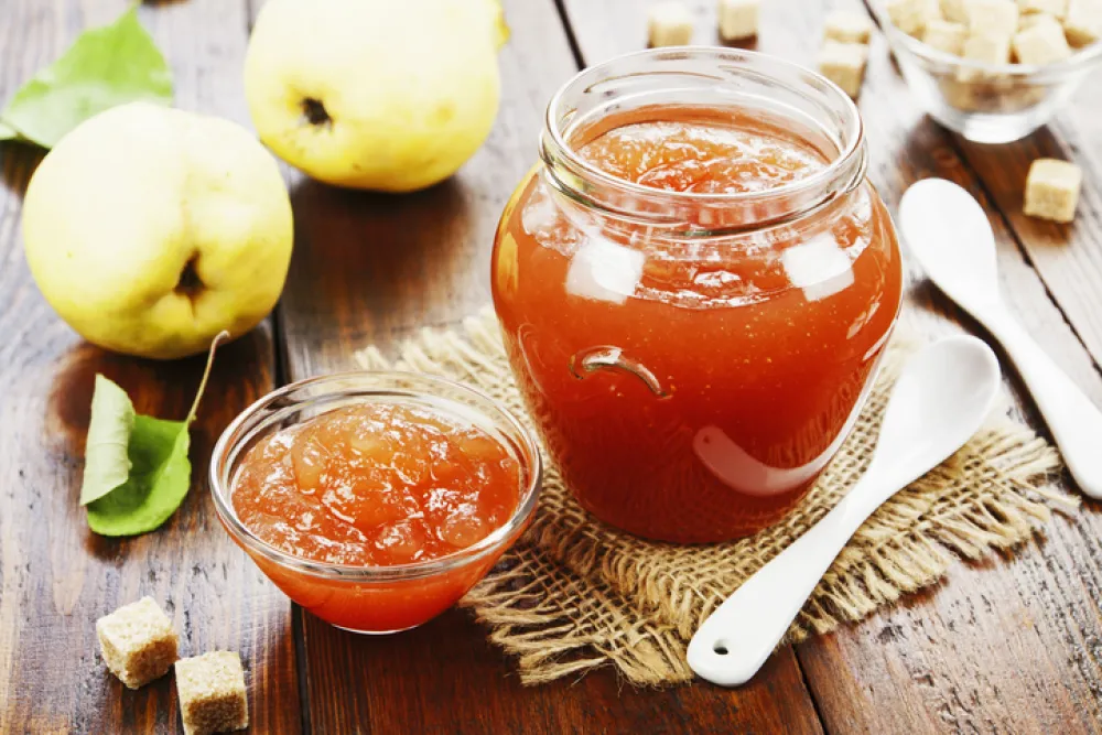 Fresh quince jam on the wooden table