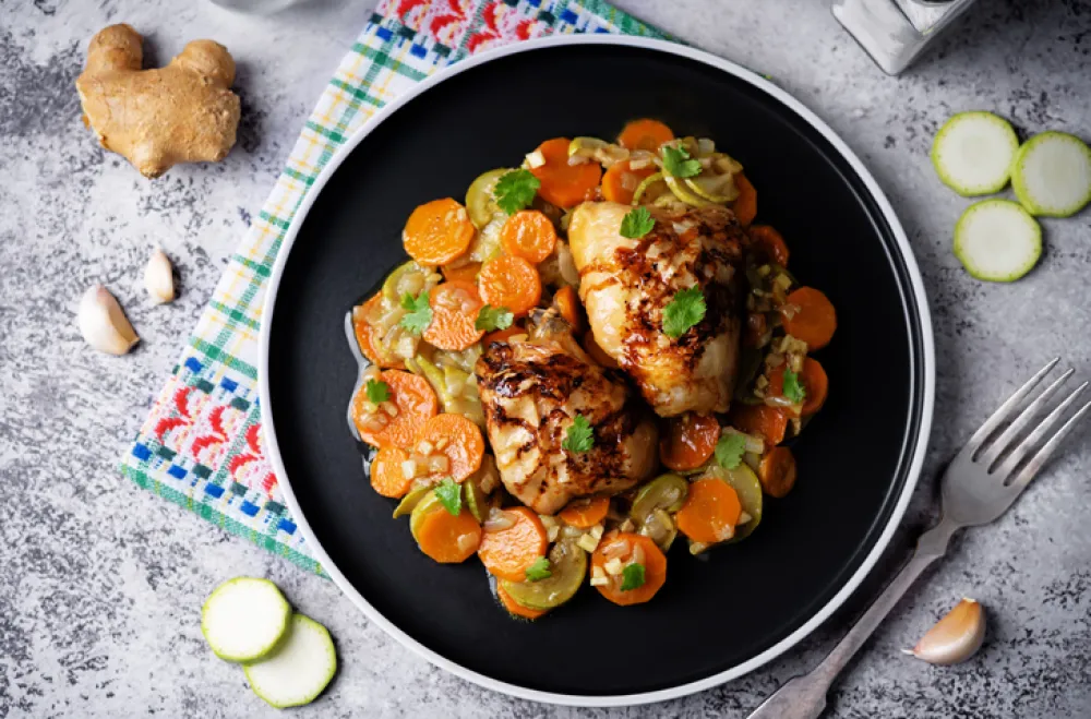 Moroccan spiced chicken with zucchini and carrots in a plate. toning