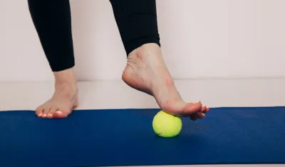 The Tennis Ball Treatment. The ball will apply pressure to the painful spot and raise the procedure. Image with copy space