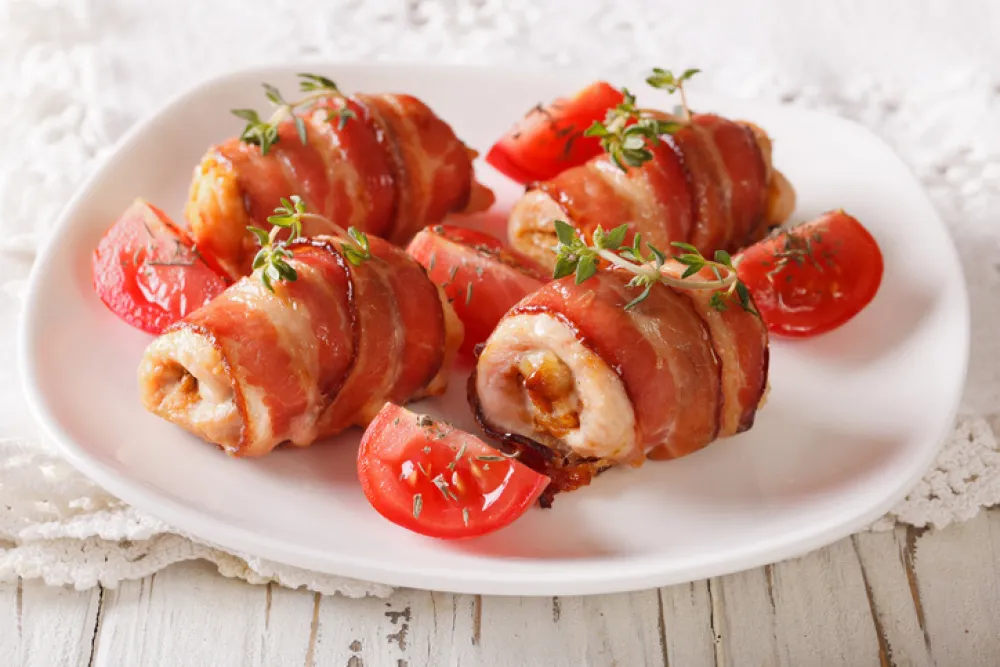 Delicious Chicken rolls with cheese and bacon on a plate close-up. horizontal<br>