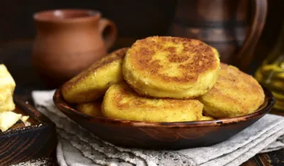 Fried potato patties with cheese on a rustic background.