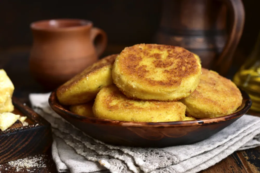 Fried potato patties with cheese on a rustic background.